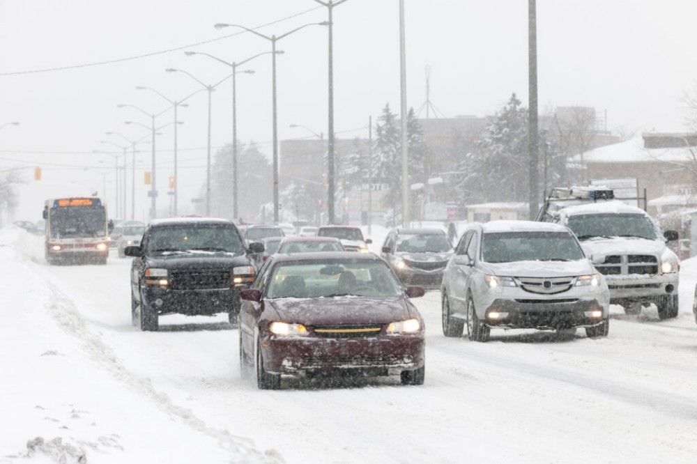 Cars Driving Along a Snow Covered Road