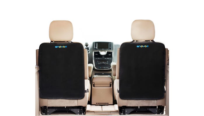 Two black seat back covers are visible from the perspective of the interior of the backseat of a car.