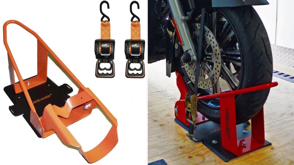 On the left, a steel black and orange wheel chock sits next to two quick-release straps. On the right, the wheel chock holds up the front tire of a motorcycle. 