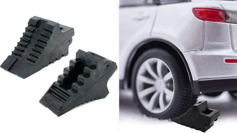 On the left, two black rubber wheel chocks with deep ridges on their surface sit side-by-side. On the right, the wheel chock sits under the tire of a parked vehicle. 