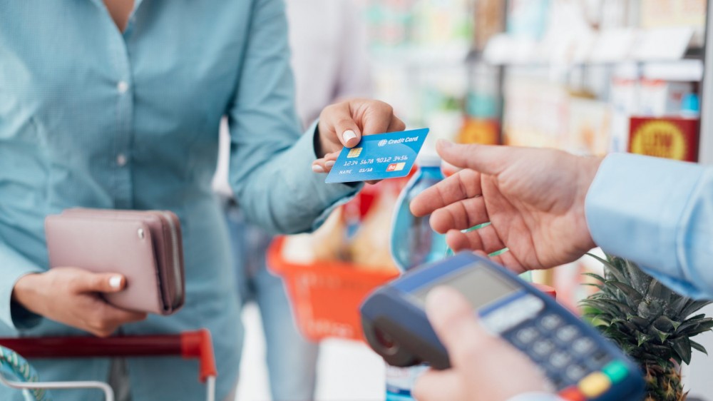 A woman pays with a credit card.